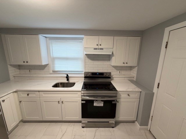 2 Gladeside Terrace, Unit 1 Boston, MA 02126 - Photo 6 of 20 a kitchen with white cabinets and appliances