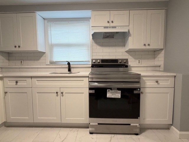 2 Gladeside Terrace, Unit 1 Boston, MA 02126 - Photo 9 of 20 a kitchen with white cabinets and appliances