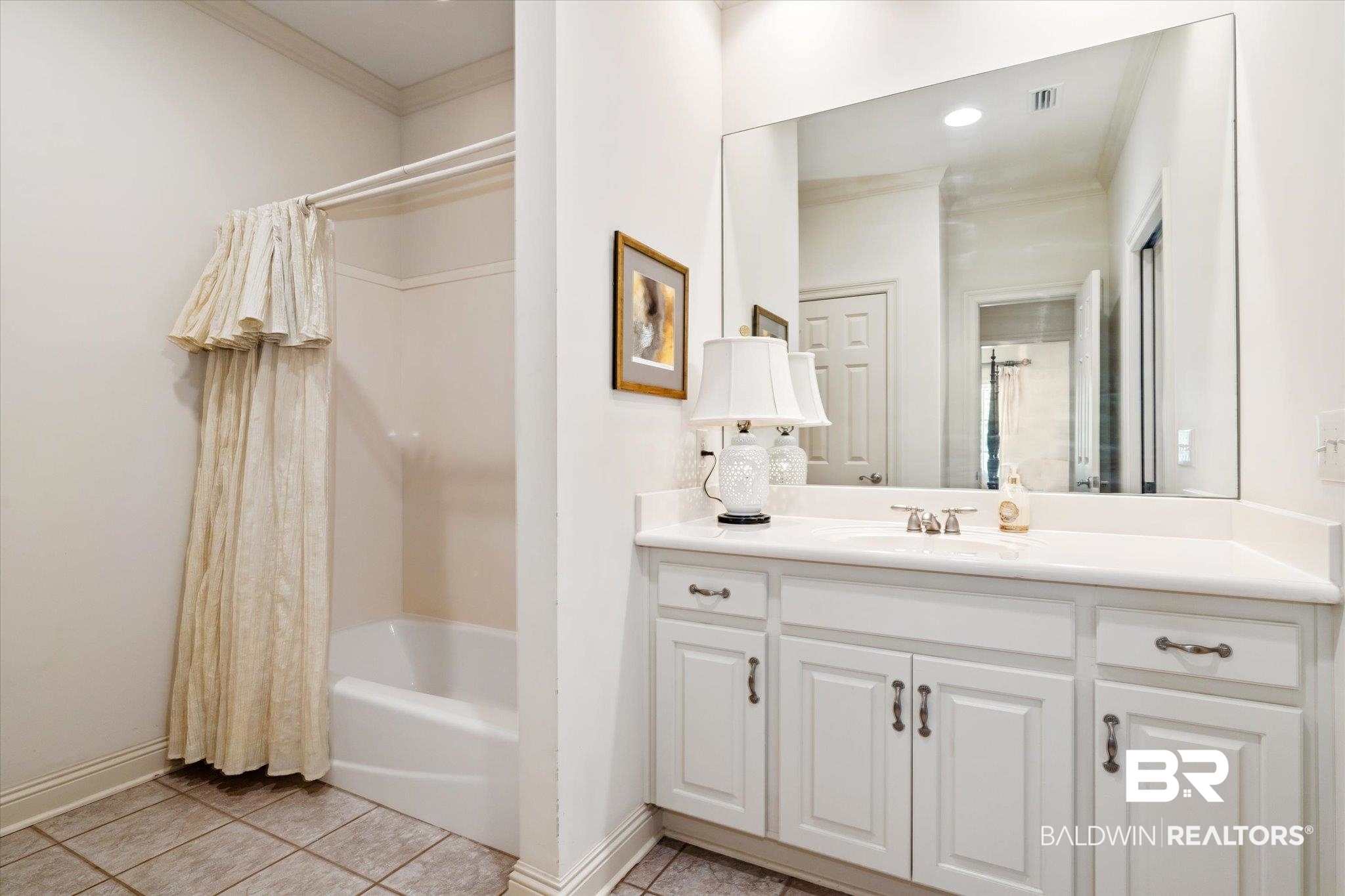 3963 Wimbledon Park Mobile, AL 36608 - Photo 39 of 51 Bathroom featuring crown molding, tile patterned flooring, shower / tub combo with curtain, and vanity