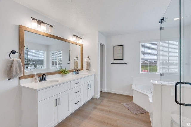 3452 Mapleton Hts Drive Mapleton, UT 84664 - Photo 16 of 40 Dual vanity with white cabinetry and dark hardware, large wood-framed mirror, contemporary light fixtures, and glass-enclosed shower