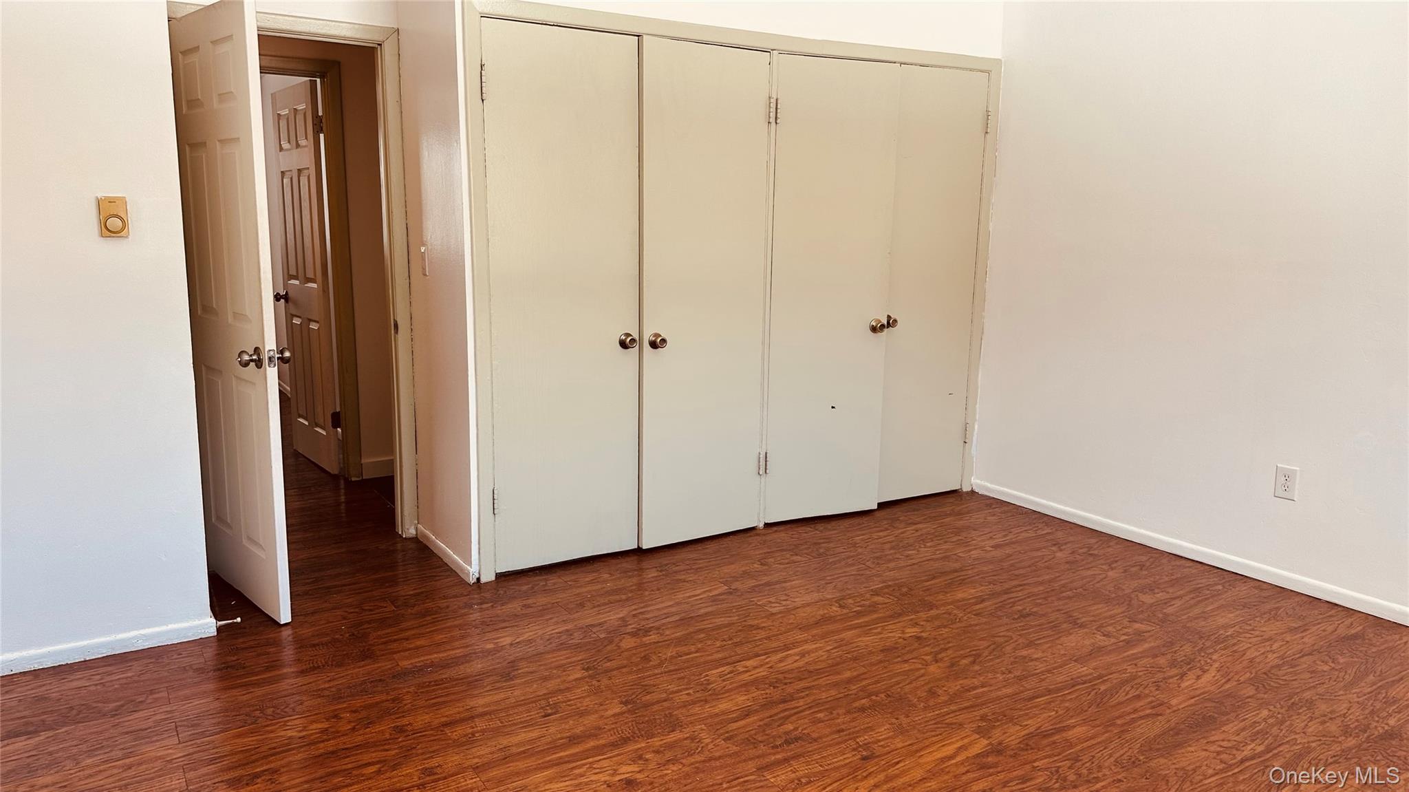 881 Albany Post Road, Unit 17 New Paltz, NY 12561 - Photo 14 of 15 a view of an empty room with wooden floor