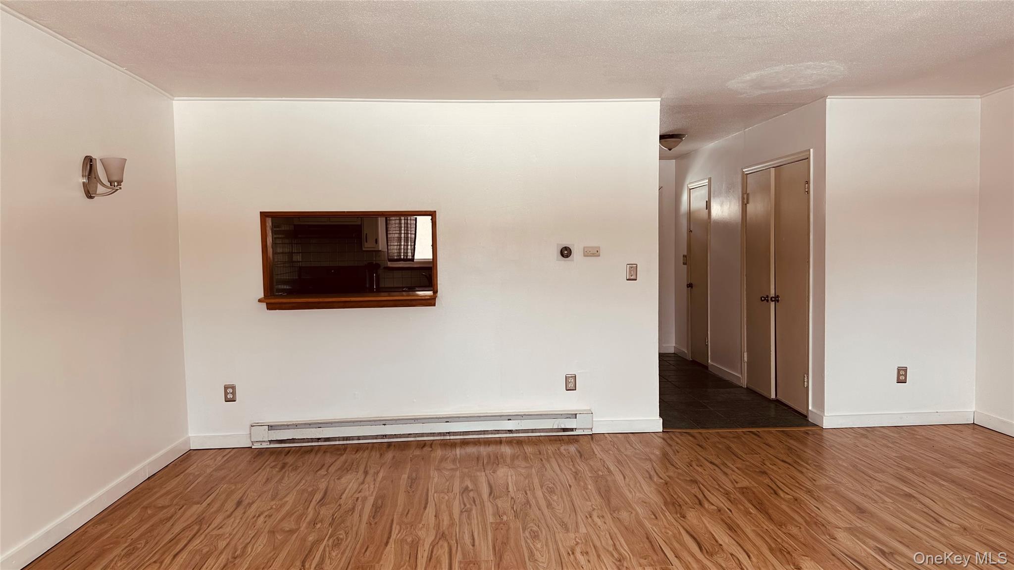 881 Albany Post Road, Unit 17 New Paltz, NY 12561 - Photo 8 of 15 a view of a livingroom with wooden floor