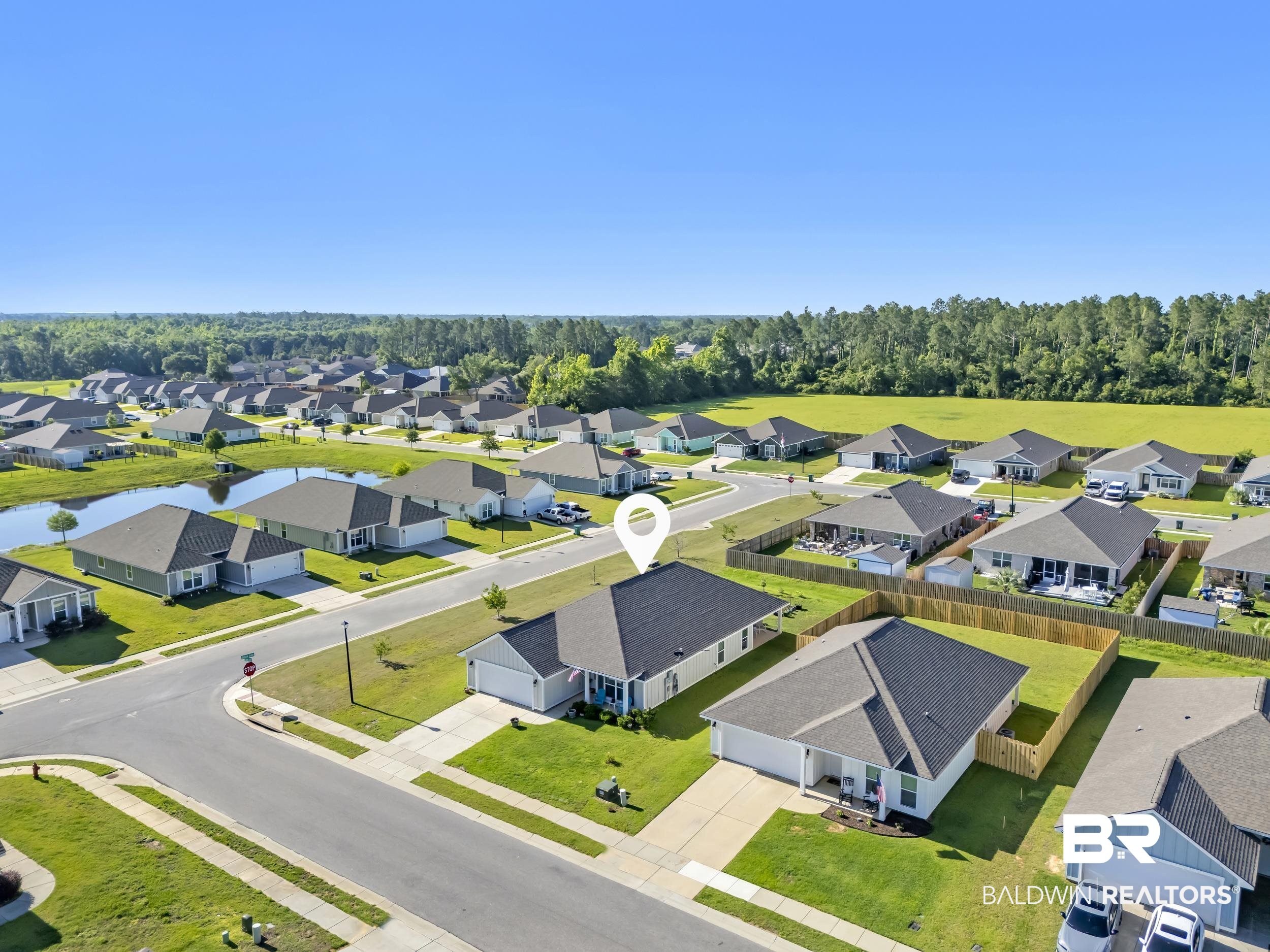 1228 Caper Avenue Foley, AL 36535 - Photo 45 of 54 Aerial perspective of a suburban neighborhood featuring single-story homes with dark shingle roofs
