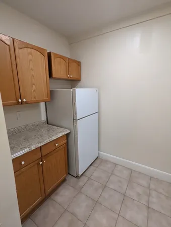 a kitchen with a refrigerator and cabinets