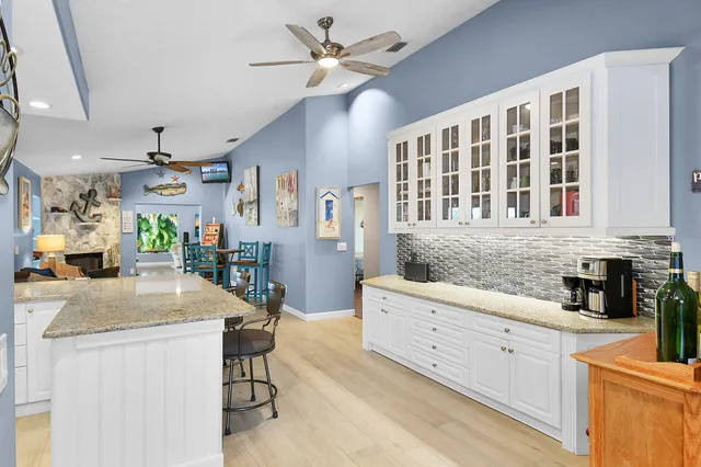 a kitchen with sink and mirror