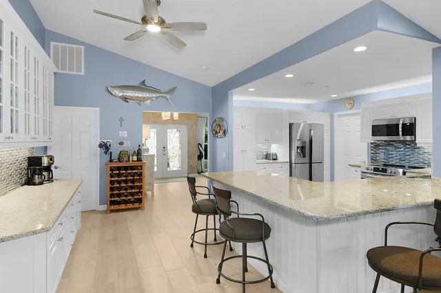 a living room with dining room and wooden floor