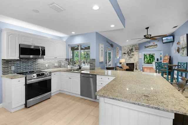 a bathroom with a glass door shower and a sink
