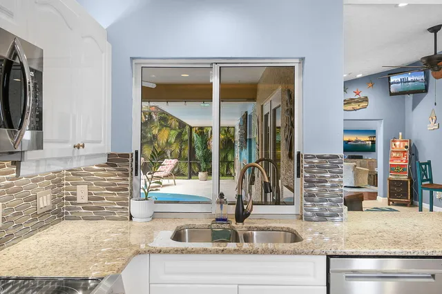 a bathroom with a granite countertop sink a mirror and shower