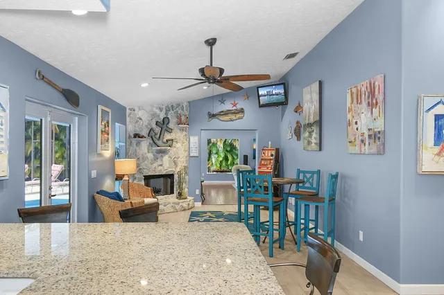 a kitchen with stainless steel appliances granite countertop a stove and a white cabinets