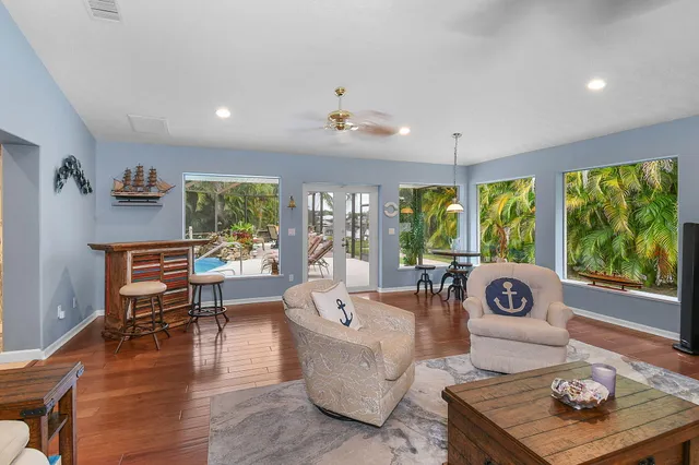 a view of a patio with table and chairs and potted plants