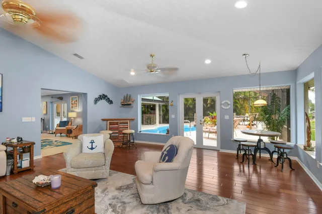 a view of a patio with a table and chairs and potted plants