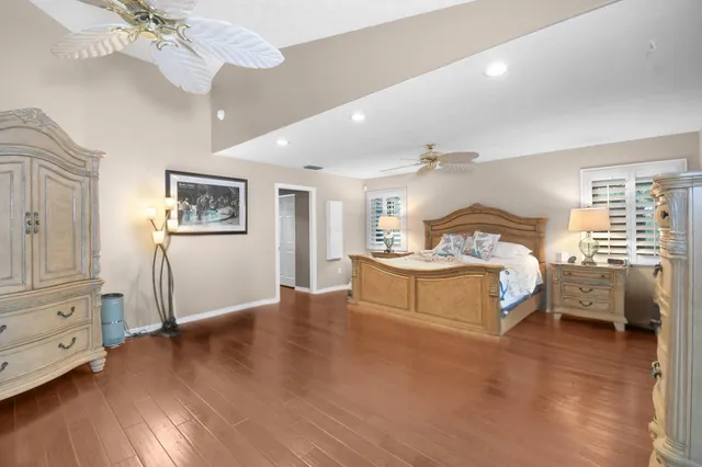 a view of a dining room with furniture large windows and wooden floor