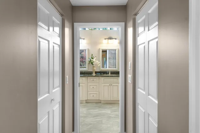 a view of a patio with a dining table and chairs under an umbrella with wooden floor