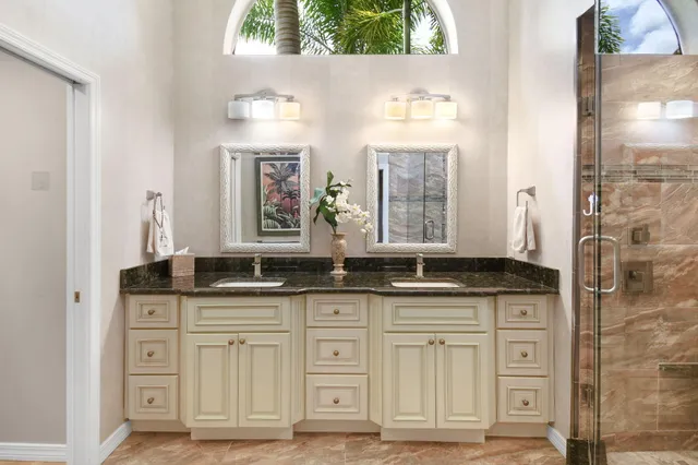a view of a patio with couches table and chairs under an umbrella