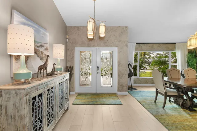 a living room with kitchen island furniture and a chandelier
