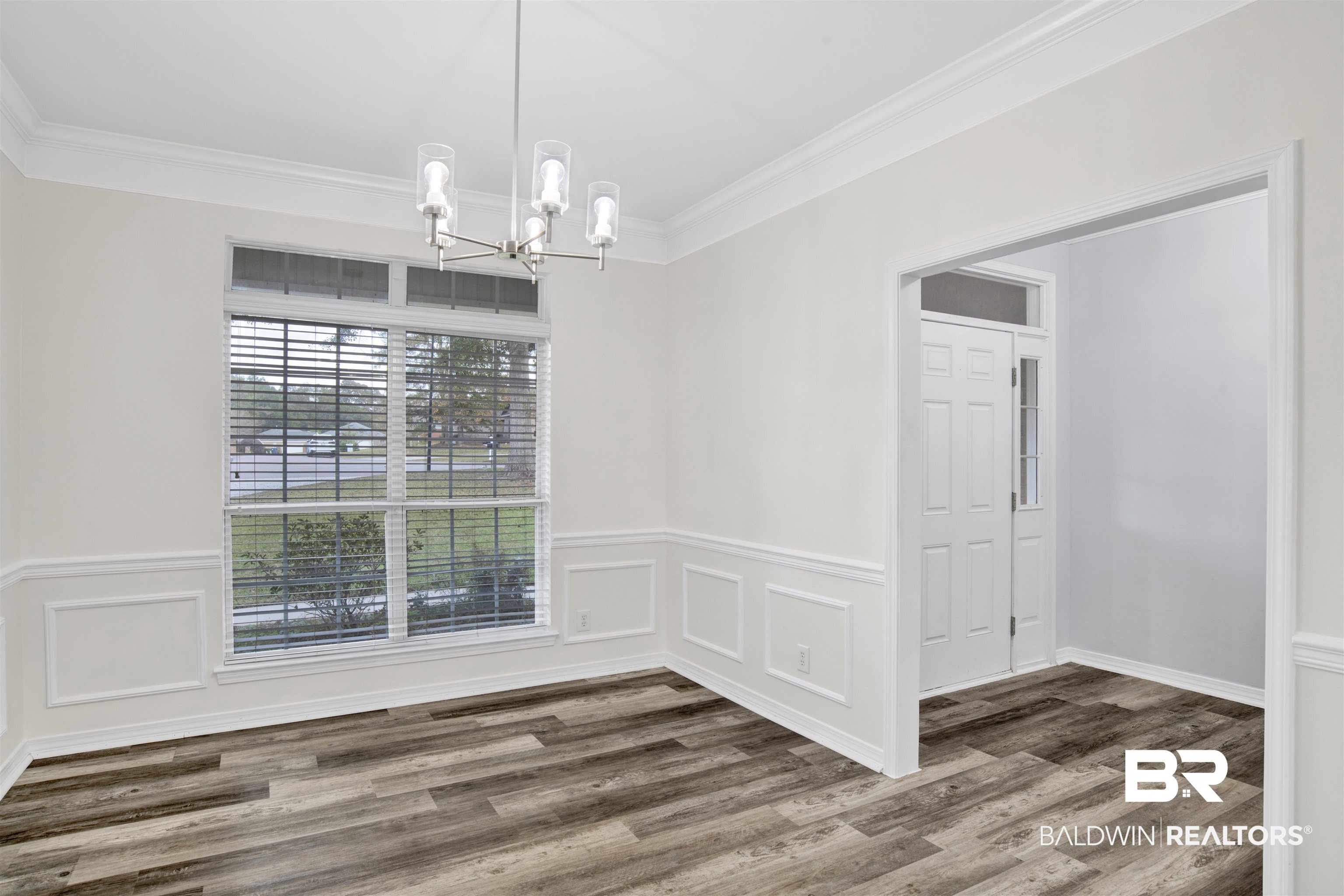 9534 Labrador Run North Mobile, AL 36695 - Photo 6 of 30 Unfurnished dining area featuring crown molding, a chandelier, and wood finished floors
