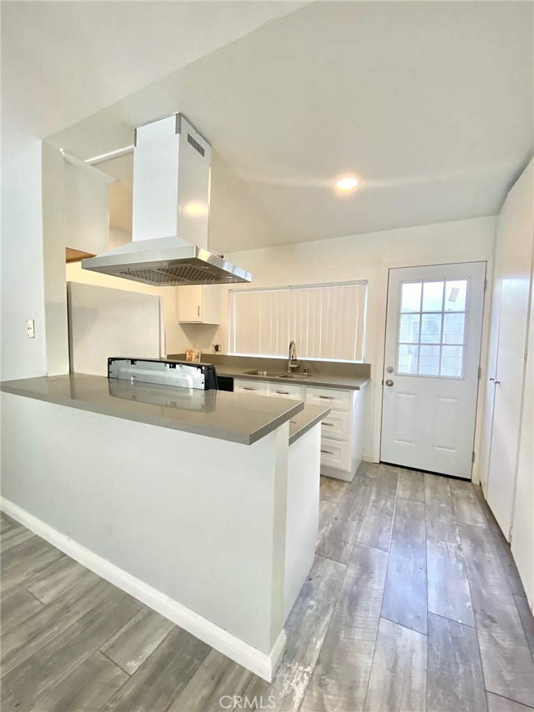 7100 Cerritos Avenue, Unit 85 Stanton, CA 90680 - Photo 5 of 9 a kitchen with a sink cabinets and wooden floor