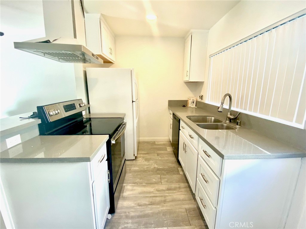 7100 Cerritos Avenue, Unit 85 Stanton, CA 90680 - Photo 6 of 9 a kitchen with stainless steel appliances granite countertop a sink a stove and a refrigerator