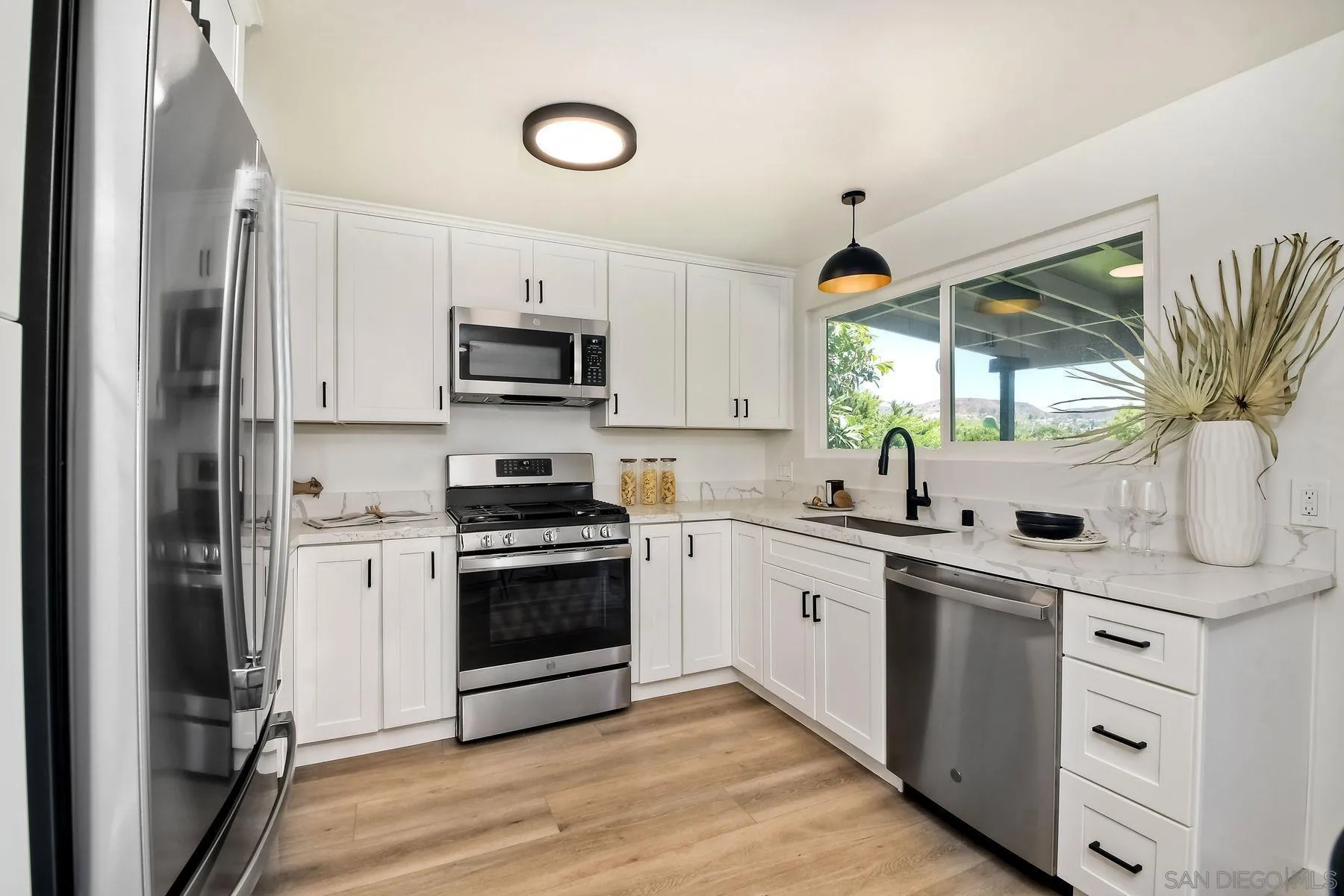 9045 Inverness Road Santee, CA 92071 - Photo 11 of 28 a kitchen with stainless steel appliances granite countertop a sink stove and refrigerator