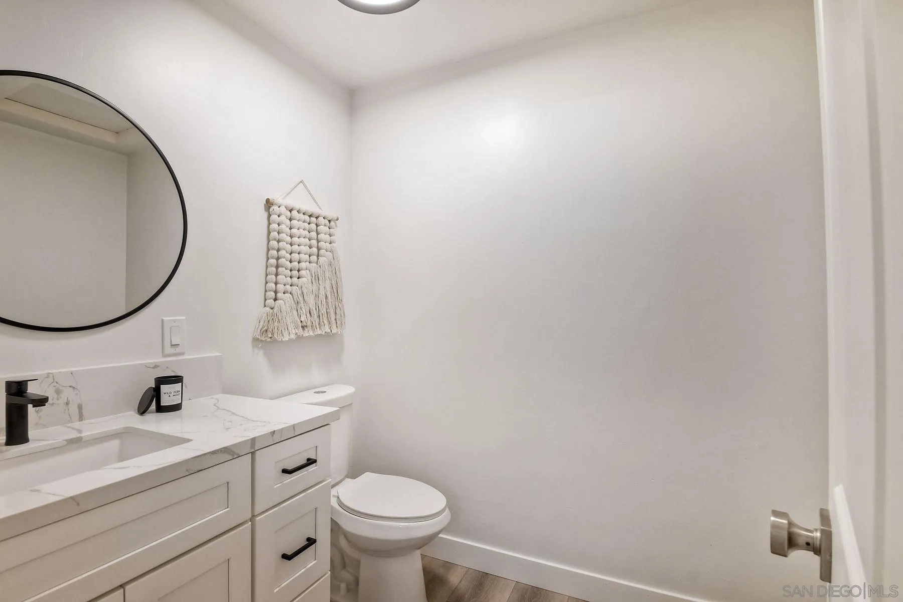 9045 Inverness Road Santee, CA 92071 - Photo 13 of 28 a bathroom with a sink mirror vanity and a toilet