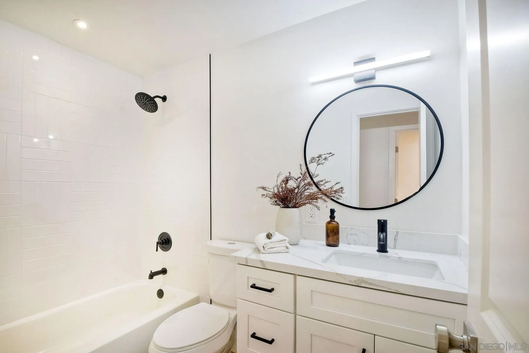9045 Inverness Road Santee, CA 92071 - Photo 17 of 28 a bathroom with a sink a toilet and a mirror