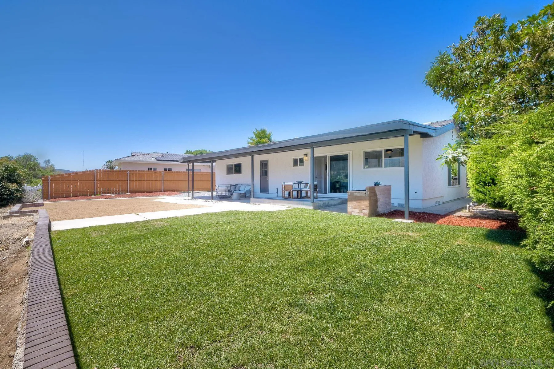 9045 Inverness Road Santee, CA 92071 - Photo 25 of 28 a view of a house with a backyard and a patio