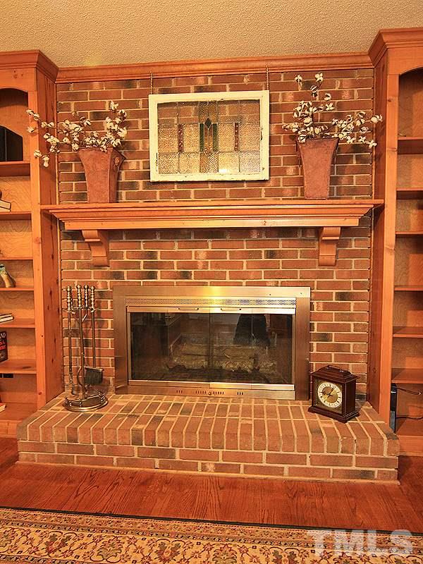 116 Hartland Court Raleigh, NC 27614 - Photo 11 of 25 Surrounded by built in bookcases this masonry wood fireplace centers this family room. Come enjoy many days and nights relaxing with family and friends. There is a lining in this fireplace that does have a warranty and will convey to next home owner.