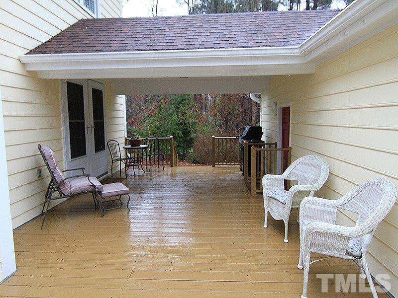 116 Hartland Court Raleigh, NC 27614 - Photo 23 of 25 Part of the deck is covered and other part is open. Great use of outdoor space between house and garage. Does not get a lot of the heat from the afternoon so you can enjoy cooking out and eating on this deck. Covered space entering home.