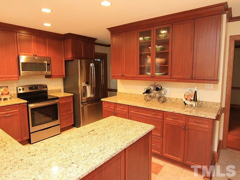 116 Hartland Court Raleigh, NC 27614 - Photo 5 of 25 Looking for a kitchen that allows plenty of working space, loads of cabinets accented with glass doors to show off some of your fun pieces, pantry for additional storage and desk area (not seen).
