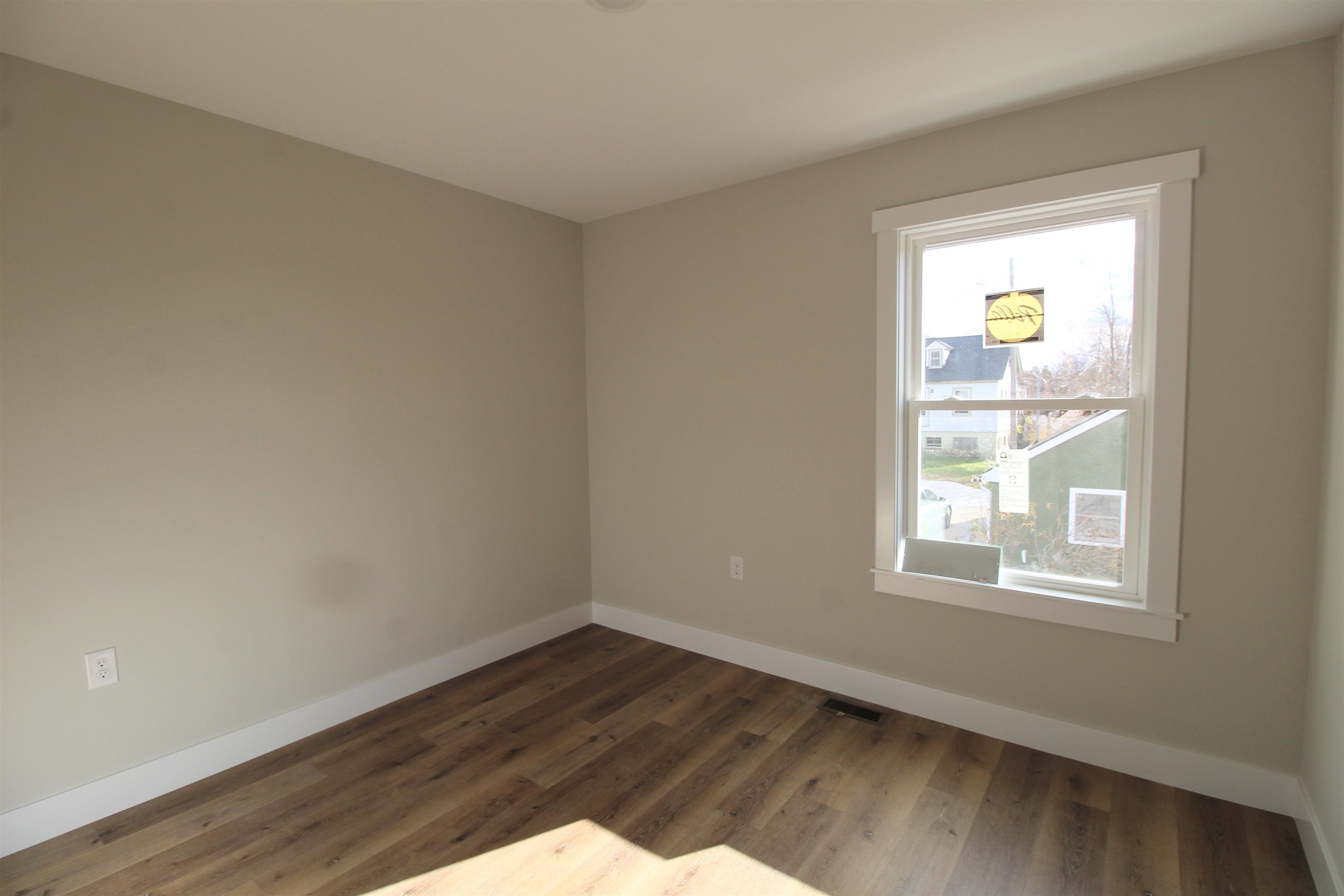 385 Effinger Street Harrisonburg, VA 22802 - Photo 4 of 9 a view of an empty room with wooden floor and a window