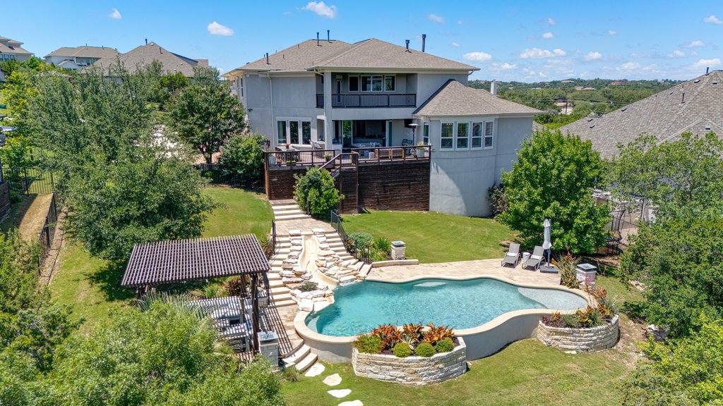 203 Lodestone Lane Austin, TX 78738 - Photo 38 of 40 Rear exterior featuring a multi-level deck, swimming pool, and a shaded pergola