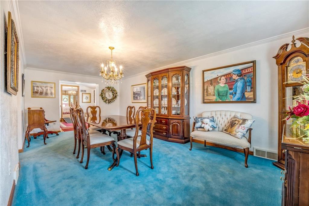 169 William Circle McKees Rocks, PA 15136 - Photo 8 of 24 a dining room with furniture a rug and a chandelier