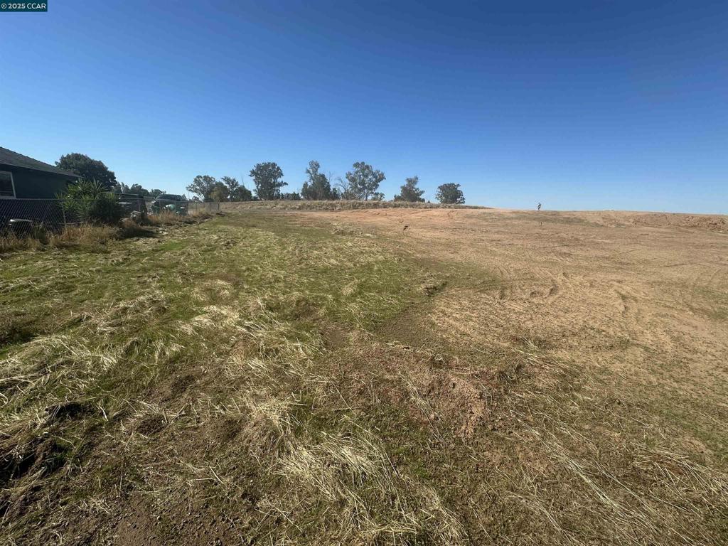 31341-31341 Brightwood Road Madera, CA 93638 - Photo 14 of 16 a view of a field with a building in the background