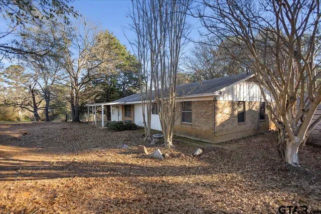 a view of a house with a yard covered in snow
