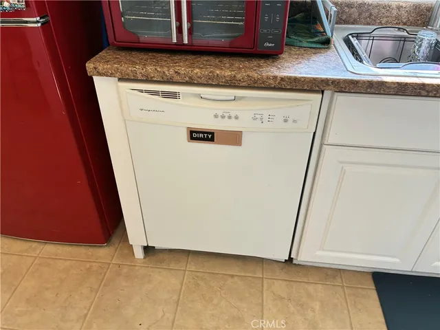 a view of kitchen island with granite countertop cabinets