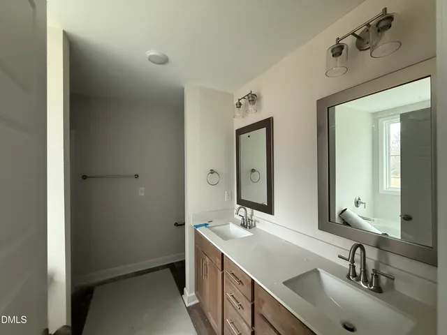 a bathroom with 2 sink and a mirror