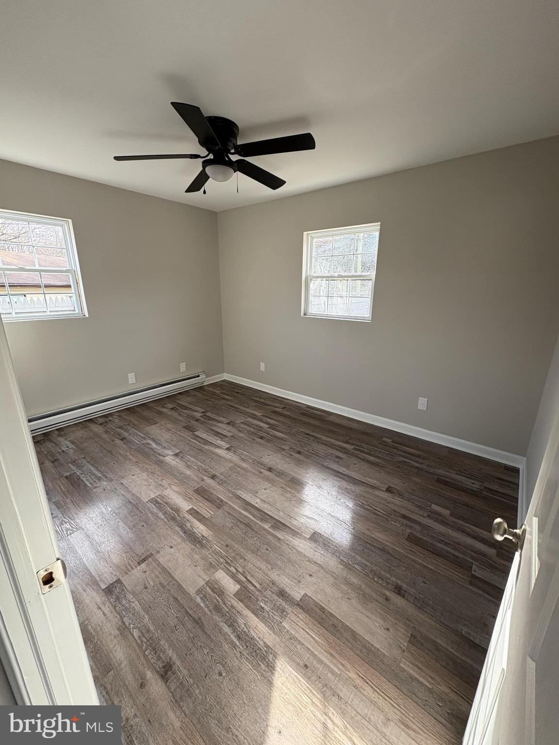 2 Kent Road Elkton, MD 21921 - Photo 13 of 17 an empty room with wooden floor ceiling fan and windows