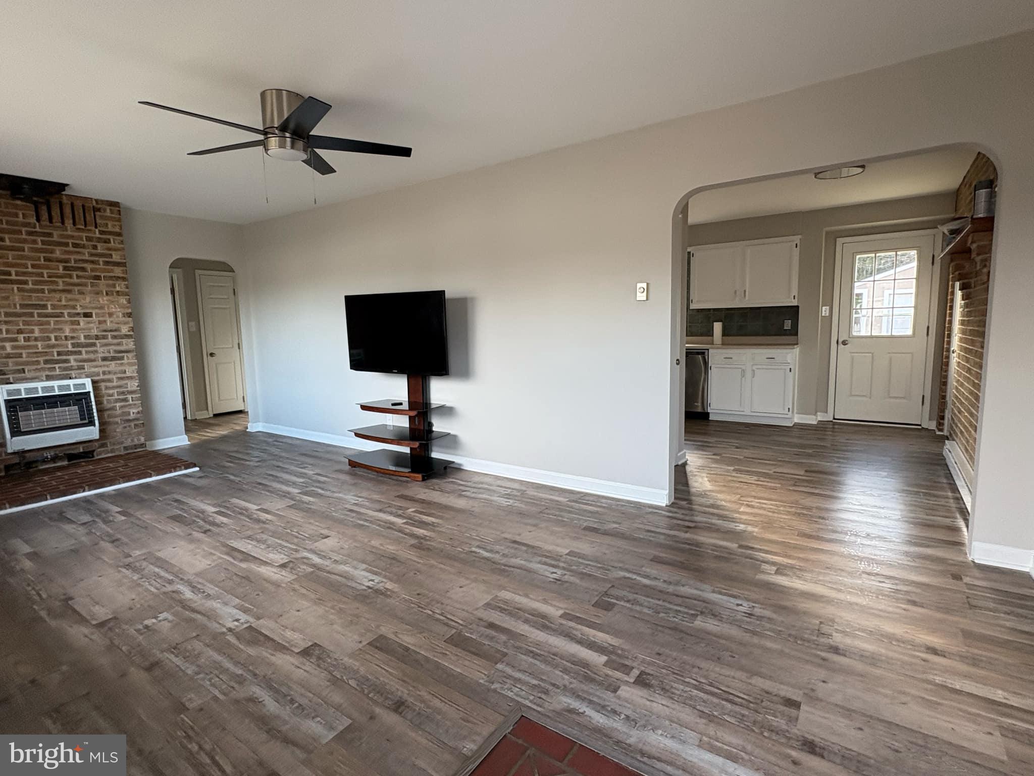 2 Kent Road Elkton, MD 21921 - Photo 5 of 17 a view of a livingroom with a flat screen tv wooden floor and a ceiling fan