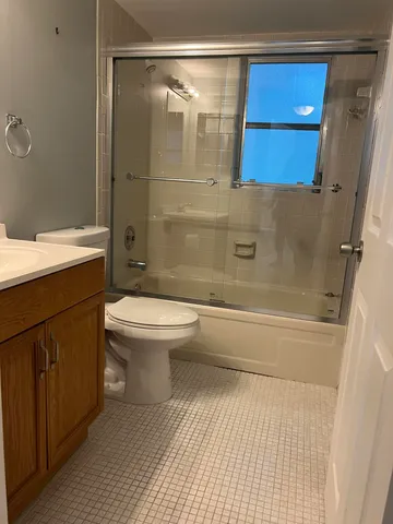 a view of a field with a tree in the background