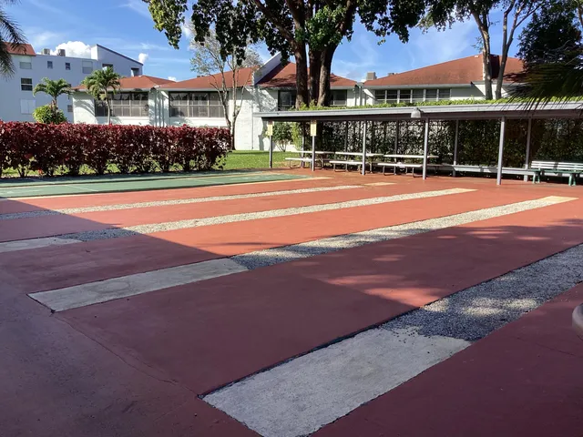 a view of a house with potted plants and a table and chairs