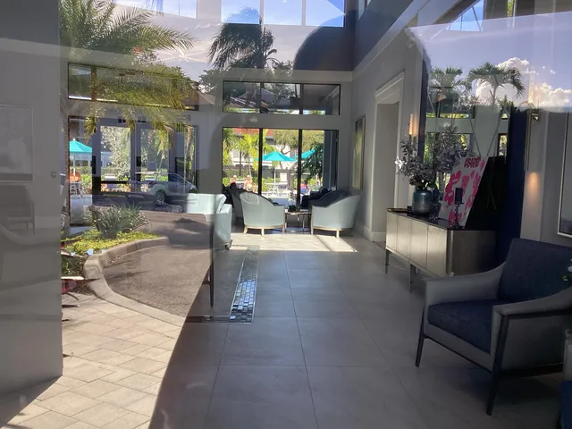 a view of a hallway view with living space and dining room view