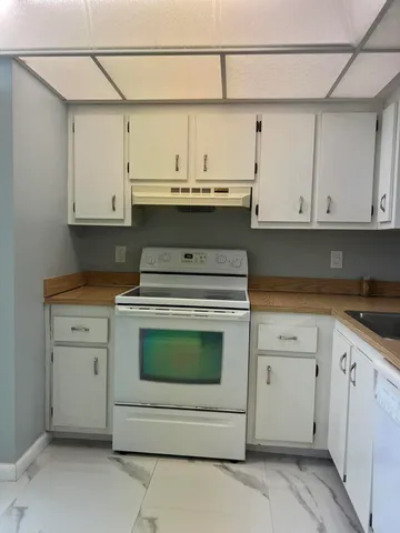 a view of a room with wooden floor and window
