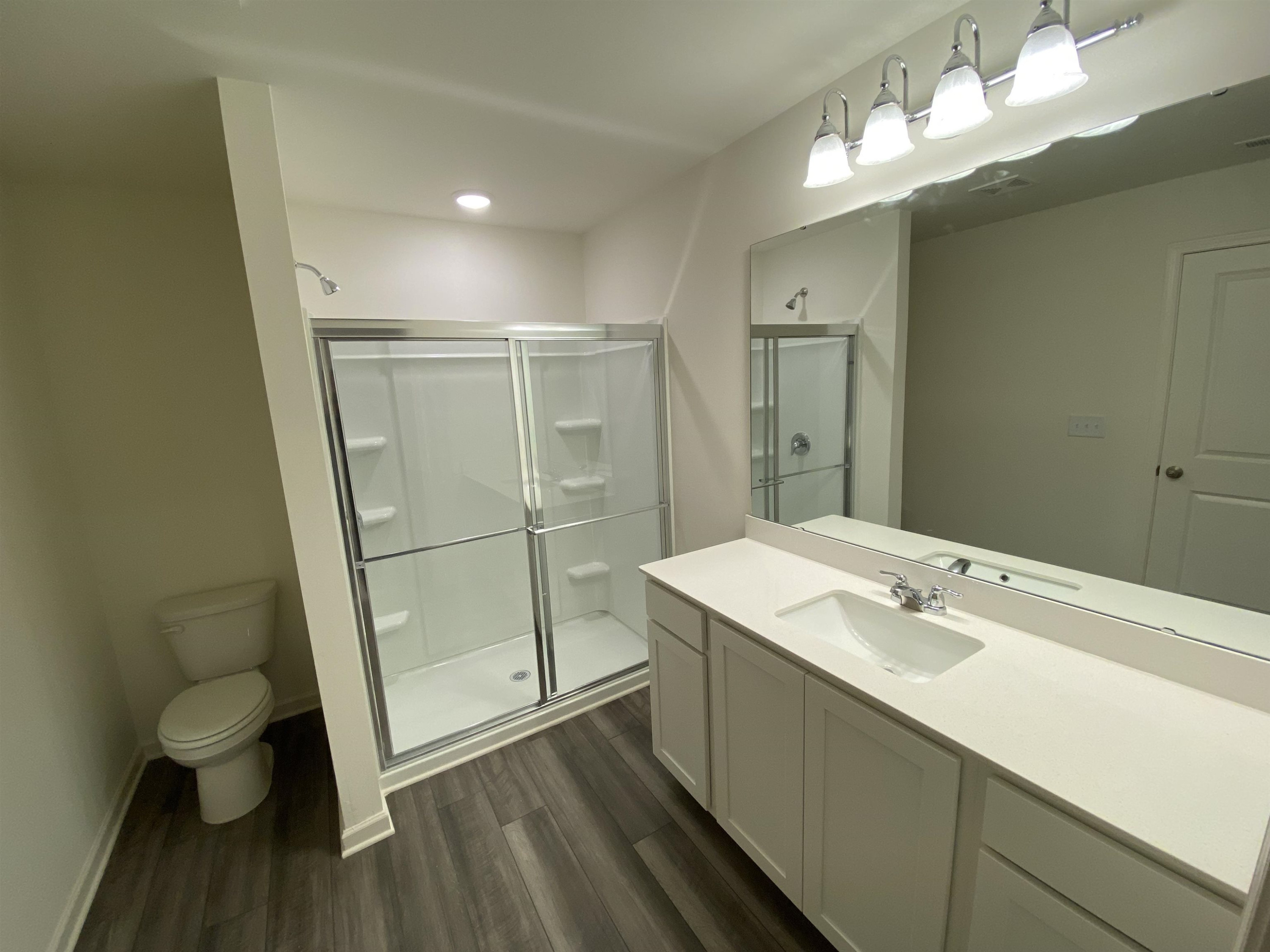 3403 Walker Drive Wilson, NC 27893 - Photo 10 of 19 a bathroom with a sink a toilet a mirror and shower