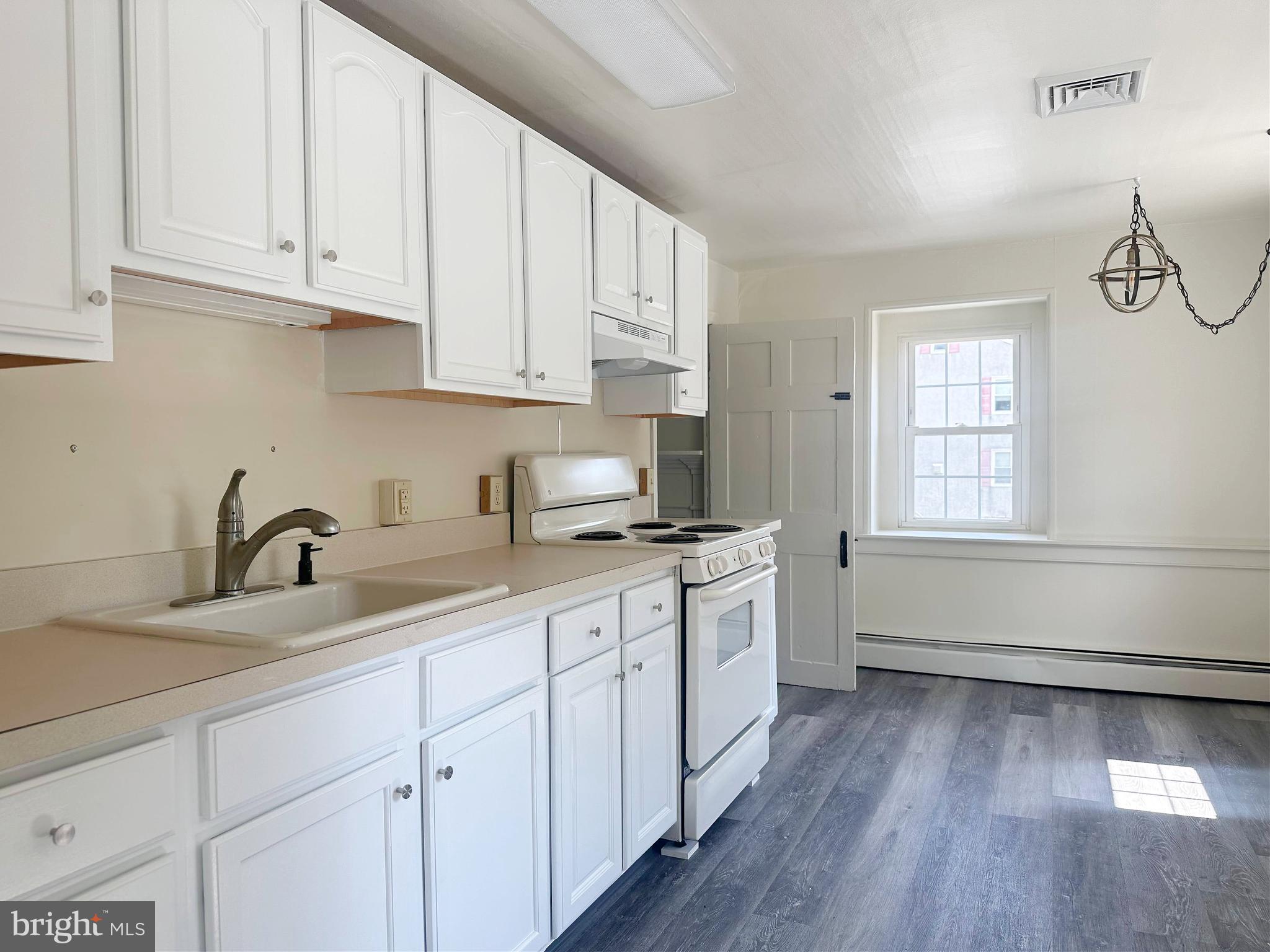 3198 Main Street Green Lane, PA 18054 - Photo 8 of 18 a kitchen with sink cabinets and wooden floor