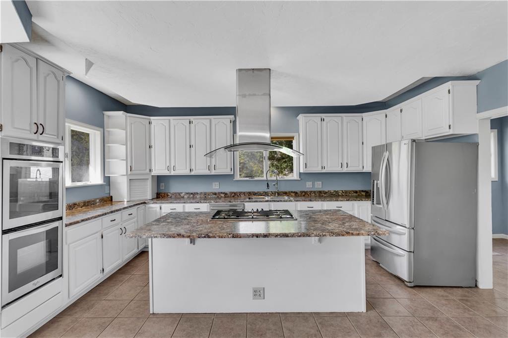 2171 Robbins Station Road Irwin, PA 15642 - Photo 14 of 50 This kitchen features a spacious layout with ample countertop space and a bright, airy atmosphere.