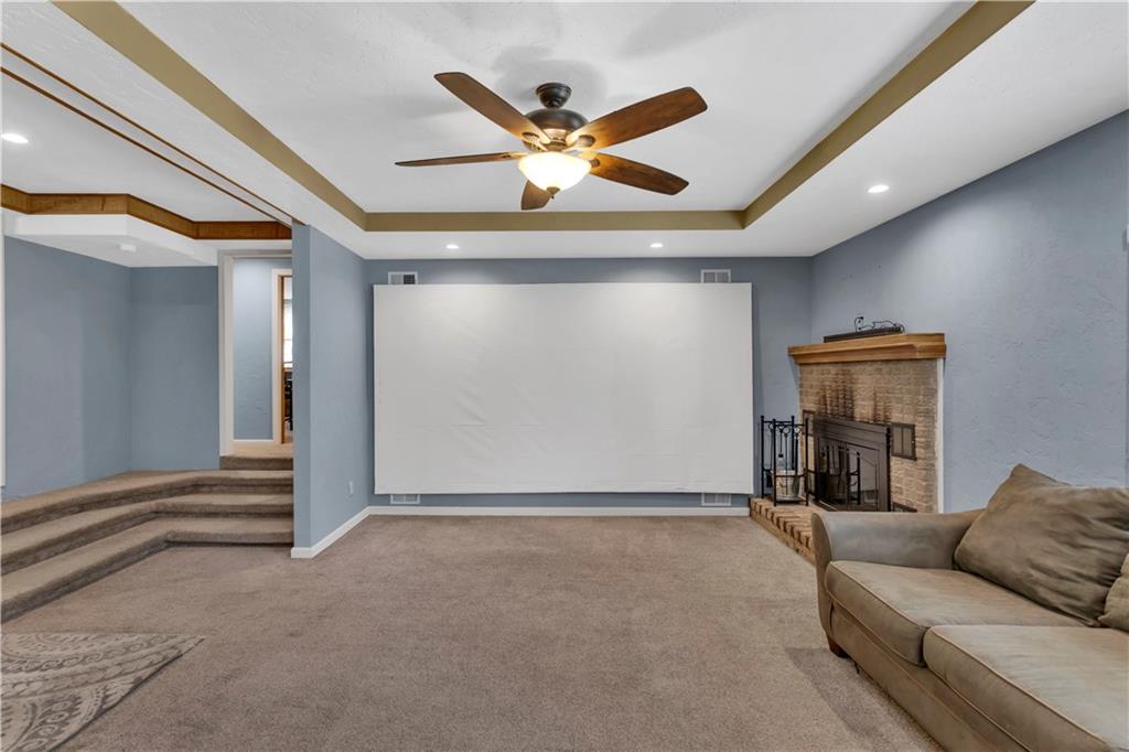 2171 Robbins Station Road Irwin, PA 15642 - Photo 21 of 50 Spacious family room with tray ceilings includes movie theater projector and a fireplace feature.