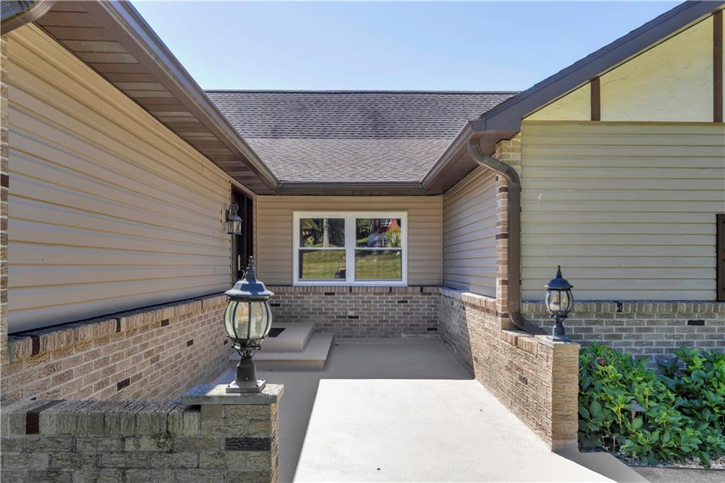 2171 Robbins Station Road Irwin, PA 15642 - Photo 7 of 50 Covered entryway, brick exterior, and landscaped grounds.