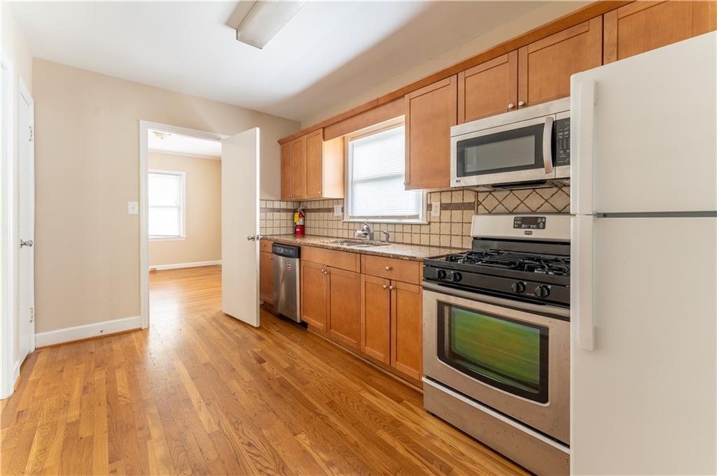 1387 Church Street Decatur, GA 30030 - Photo 14 of 37 a kitchen with stainless steel appliances a stove a sink and a microwave