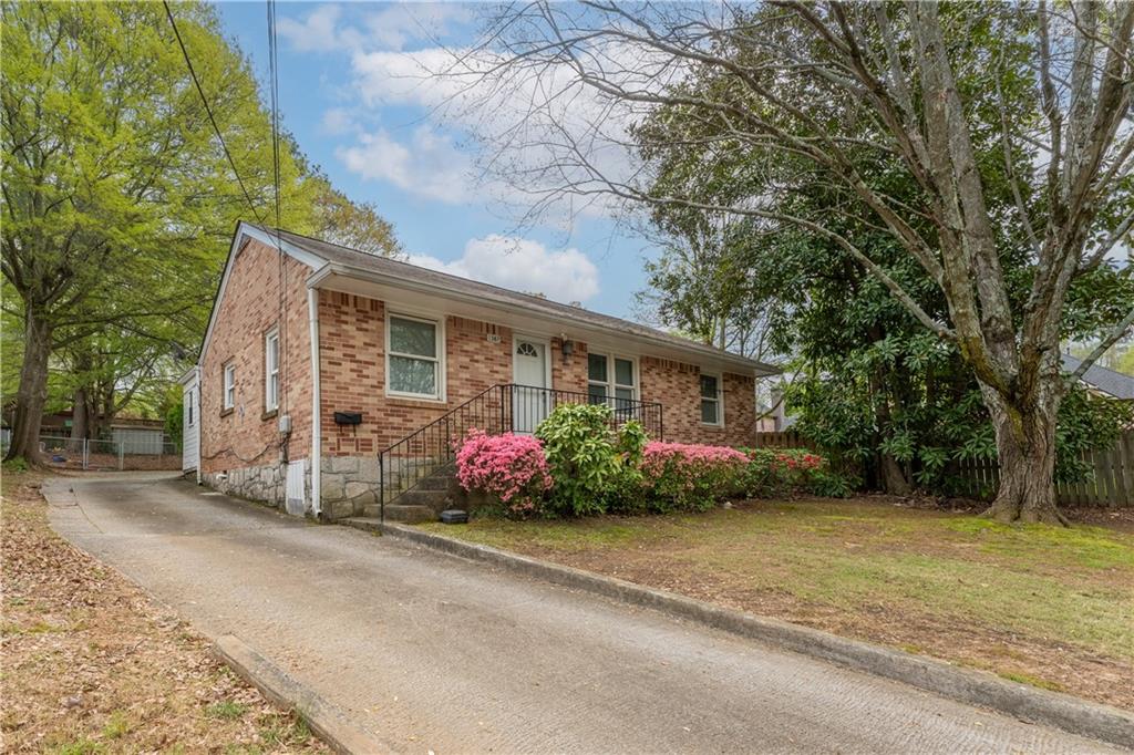 1387 Church Street Decatur, GA 30030 - Photo 3 of 37 a front view of a house with a garden and plants