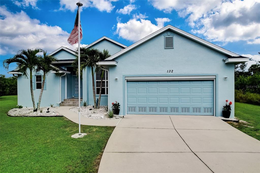 132 Venice Road Rotonda West, FL 33947 - Photo 1 of 1 a view of a house with backyard and garden